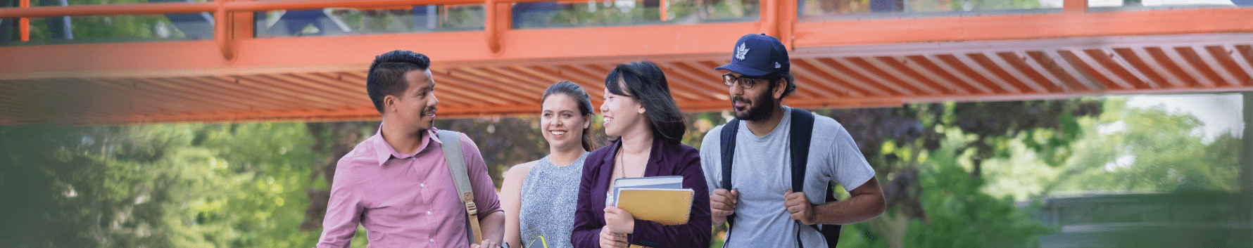 Four Sheridan students talking as they walk on campus