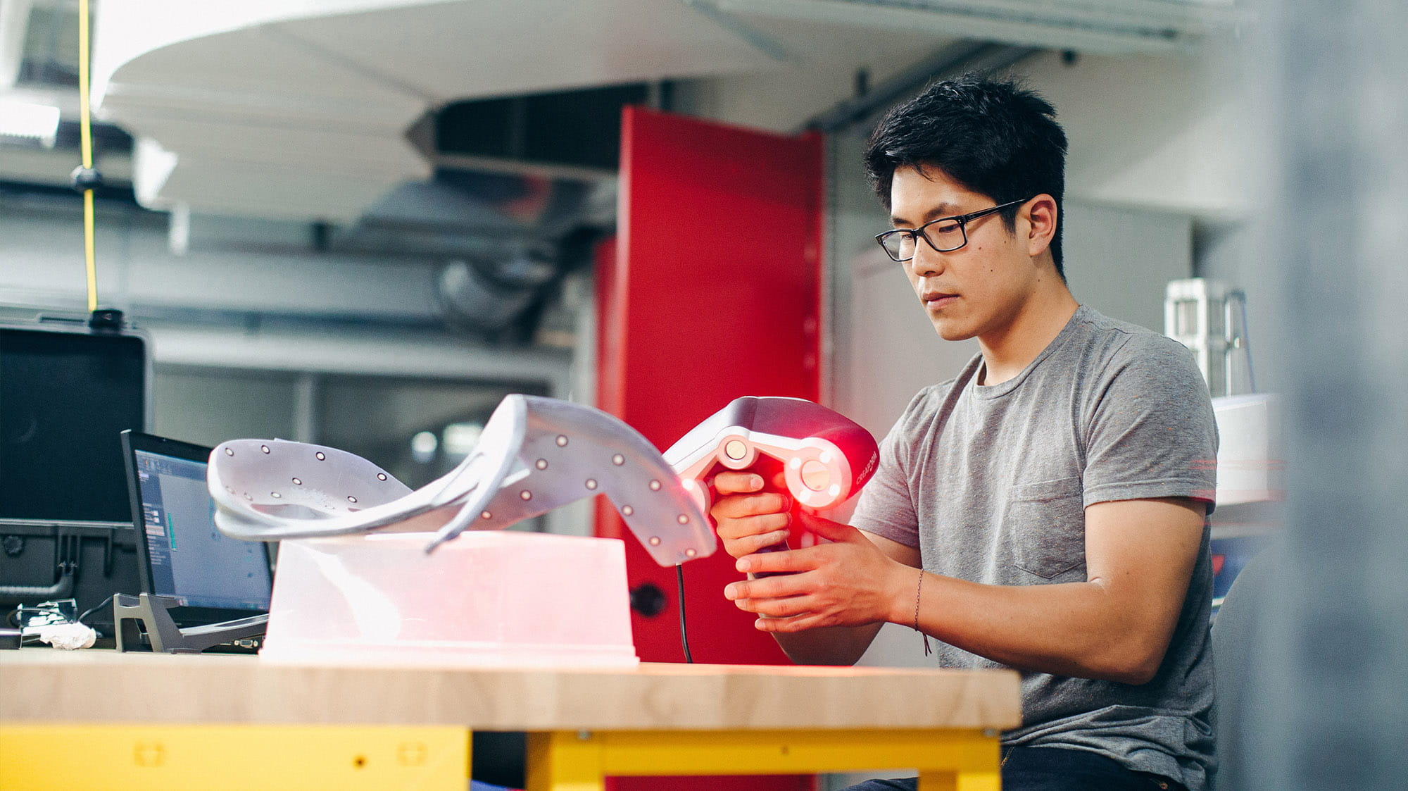 A Sheridan engineering student working with lab equipment