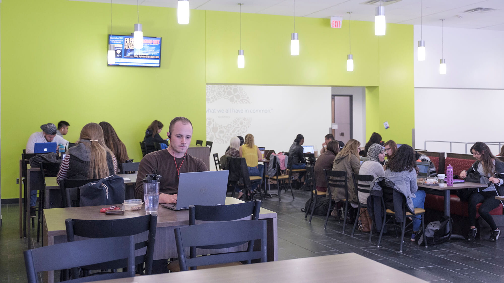 Students in groups at tables in the cafeteria