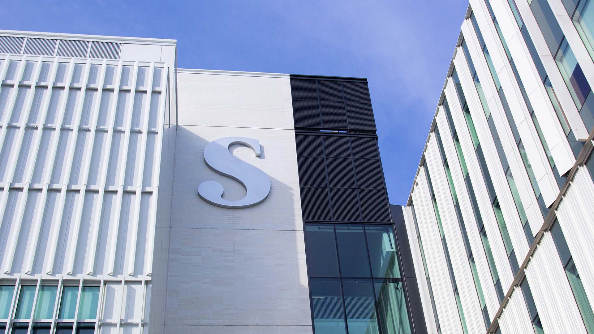 Looking upwards at the Sheridan 'S' on the exterior of the Student Centre at Hazel McCallion Campus.