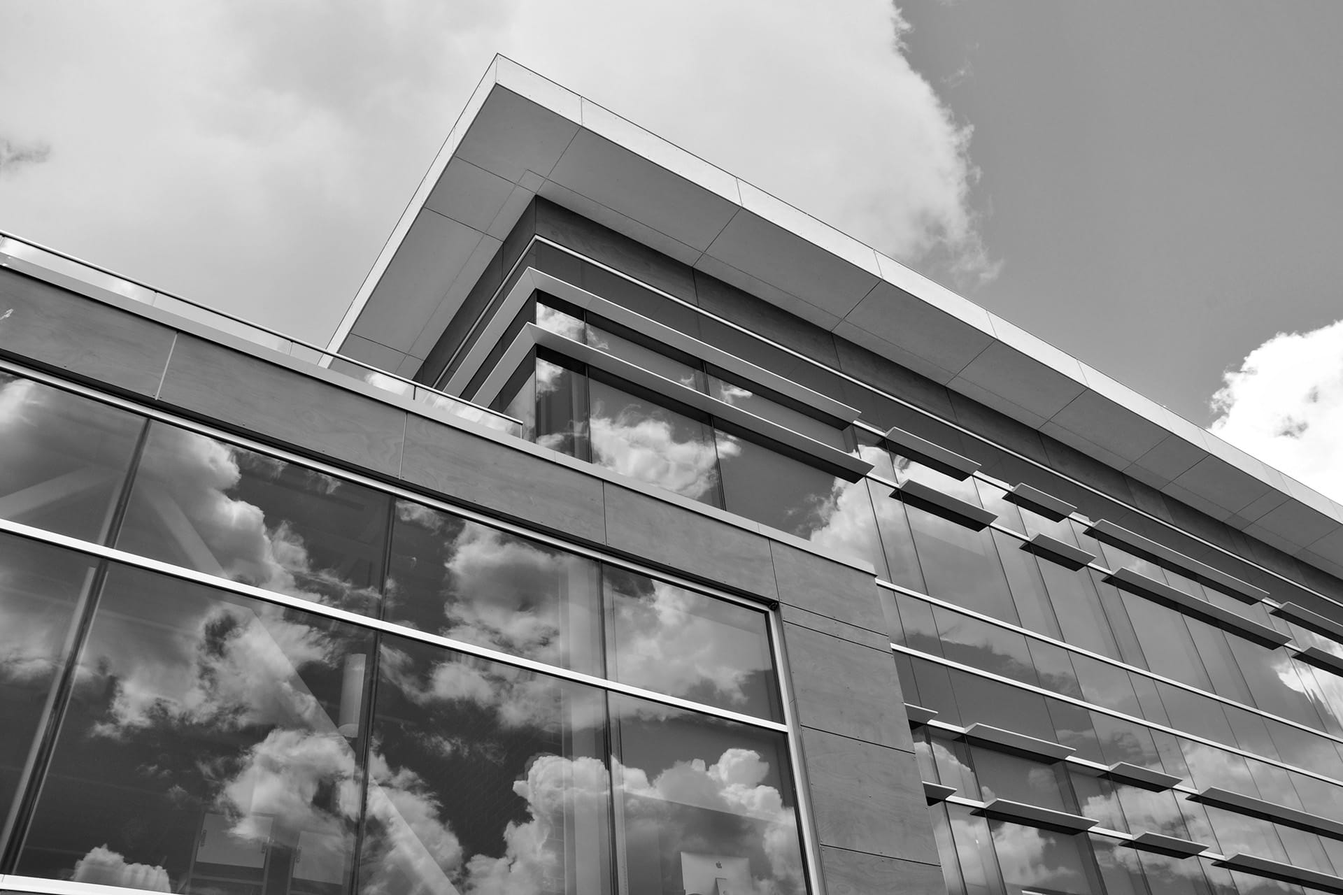 Looking up towards the sky at windows on a building