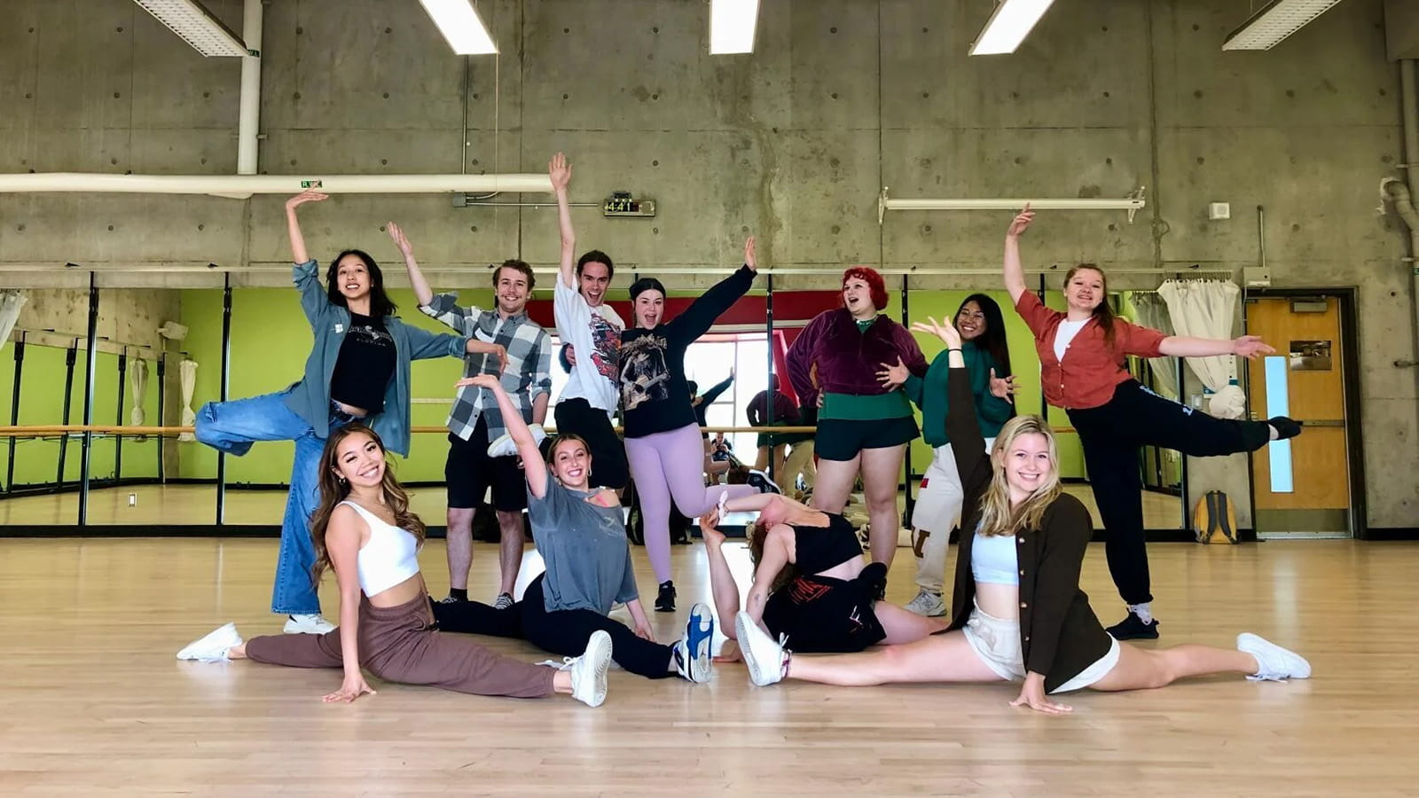 Group of students posing in dance positions in a studio