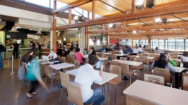 People sitting at tables in a cafeteria
