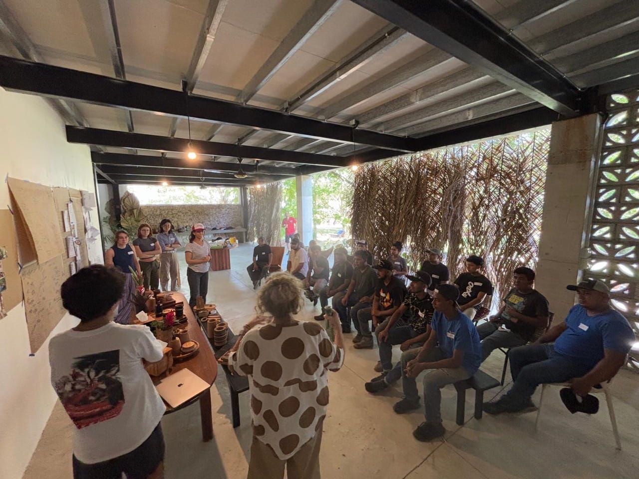 Sheridan students and staff present their collections, including design processes and prototypes, to the Itza Wood team — many of whom do not speak English.