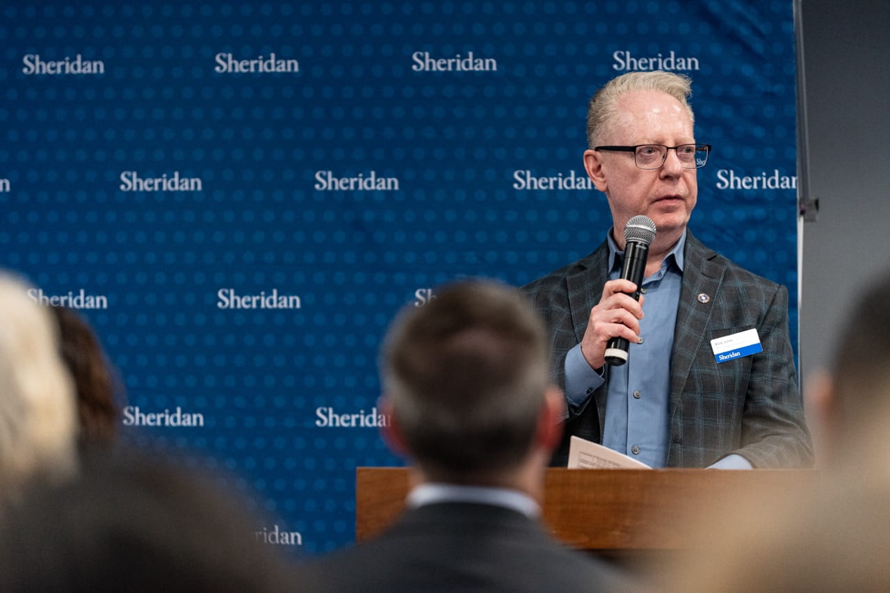 Faculty of Animation, Arts and Design Mark Jones speaks at the podium