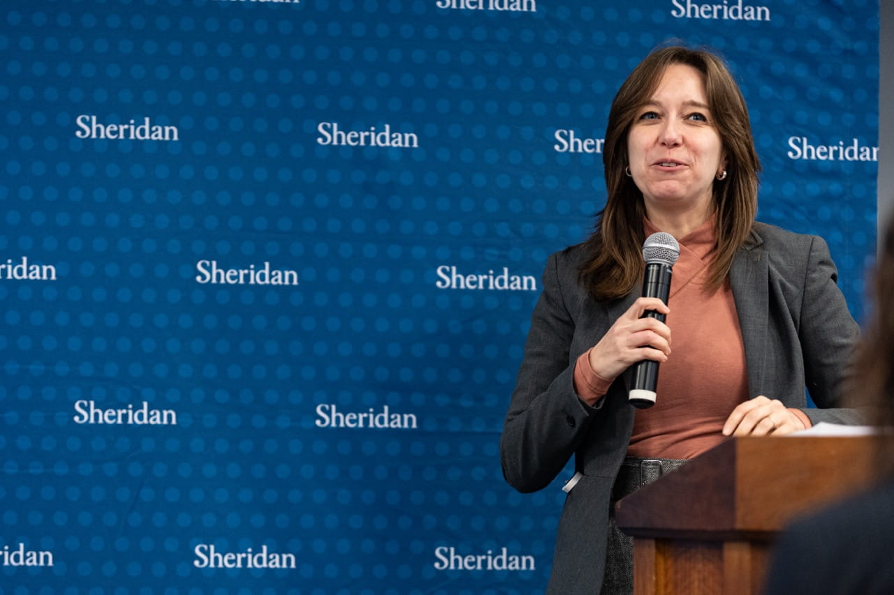 Faculty of Humanities and Social Sciences Dean Dr. Genevieve Amaral speaks at the podium