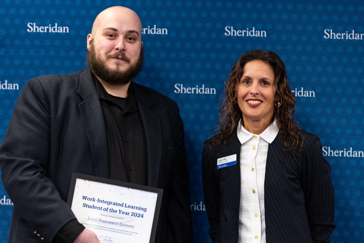 Luigi Sposato holds his certificate while standing next to Sheridan Director, Career-Integrated Learning Joanne Islip