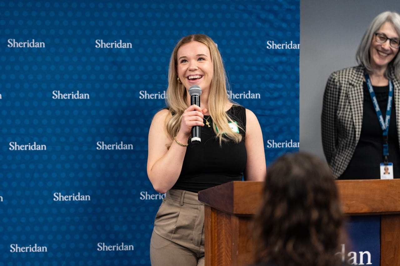 Briar Alderdice smiles while delivering a speech