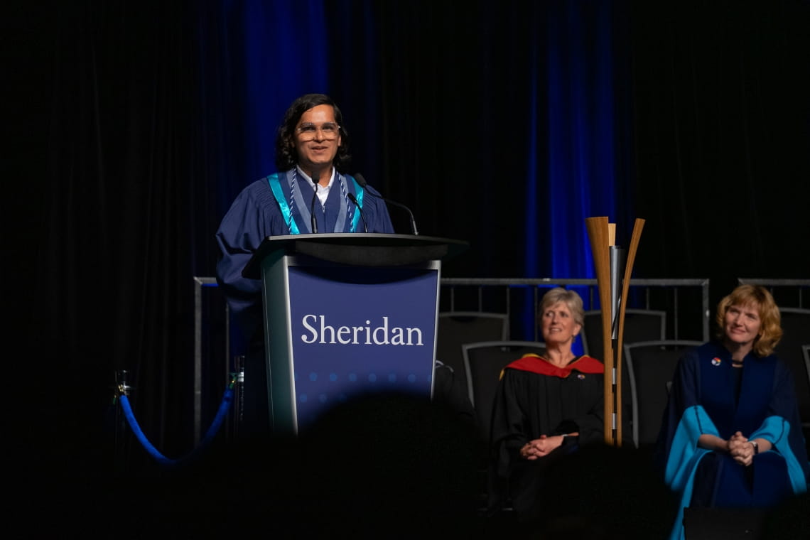 PSB valedictorian Roopam Jain gives his speech on stage at convocation