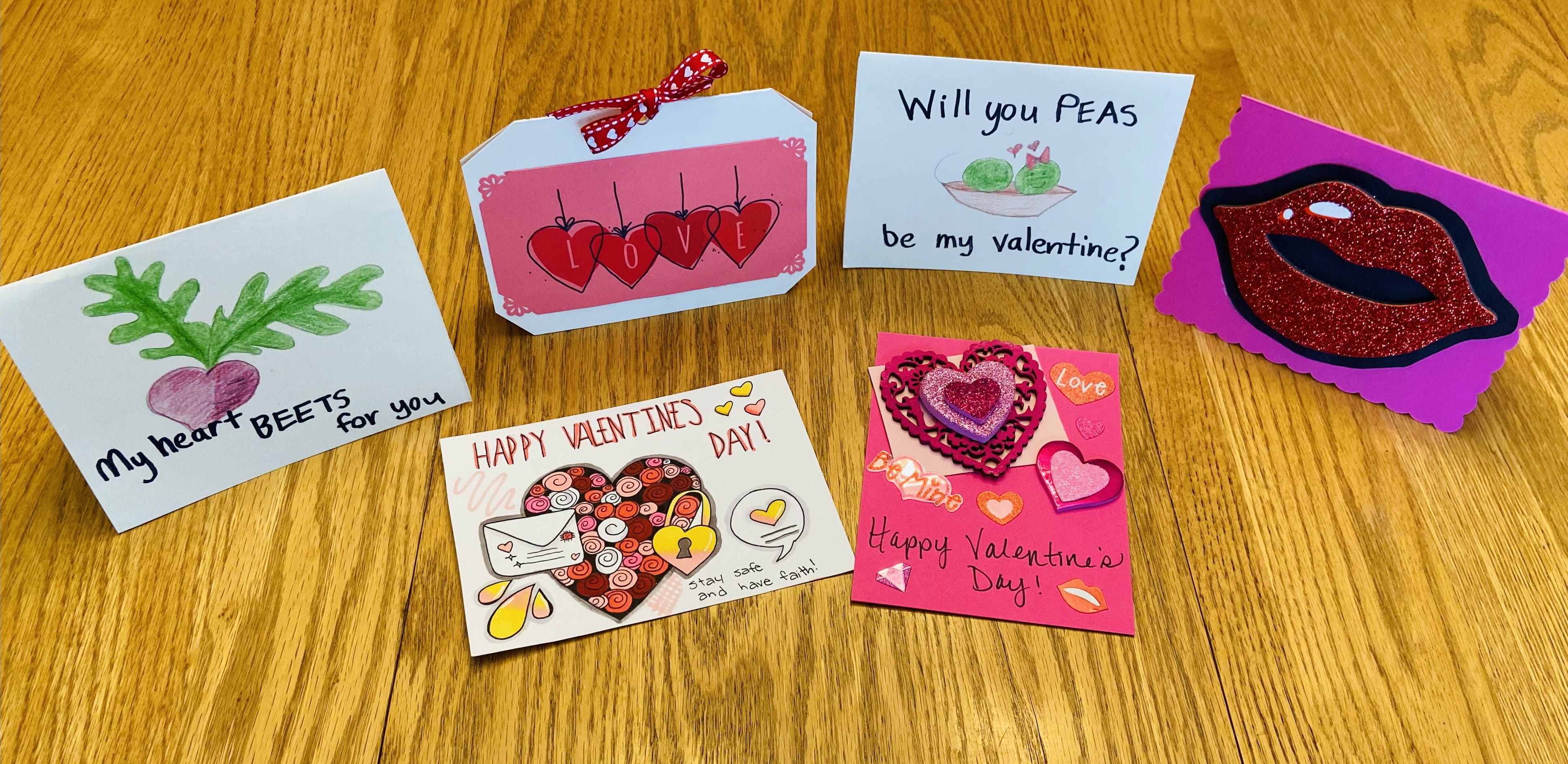 Hand-made Valentine's Day cards open on a table
