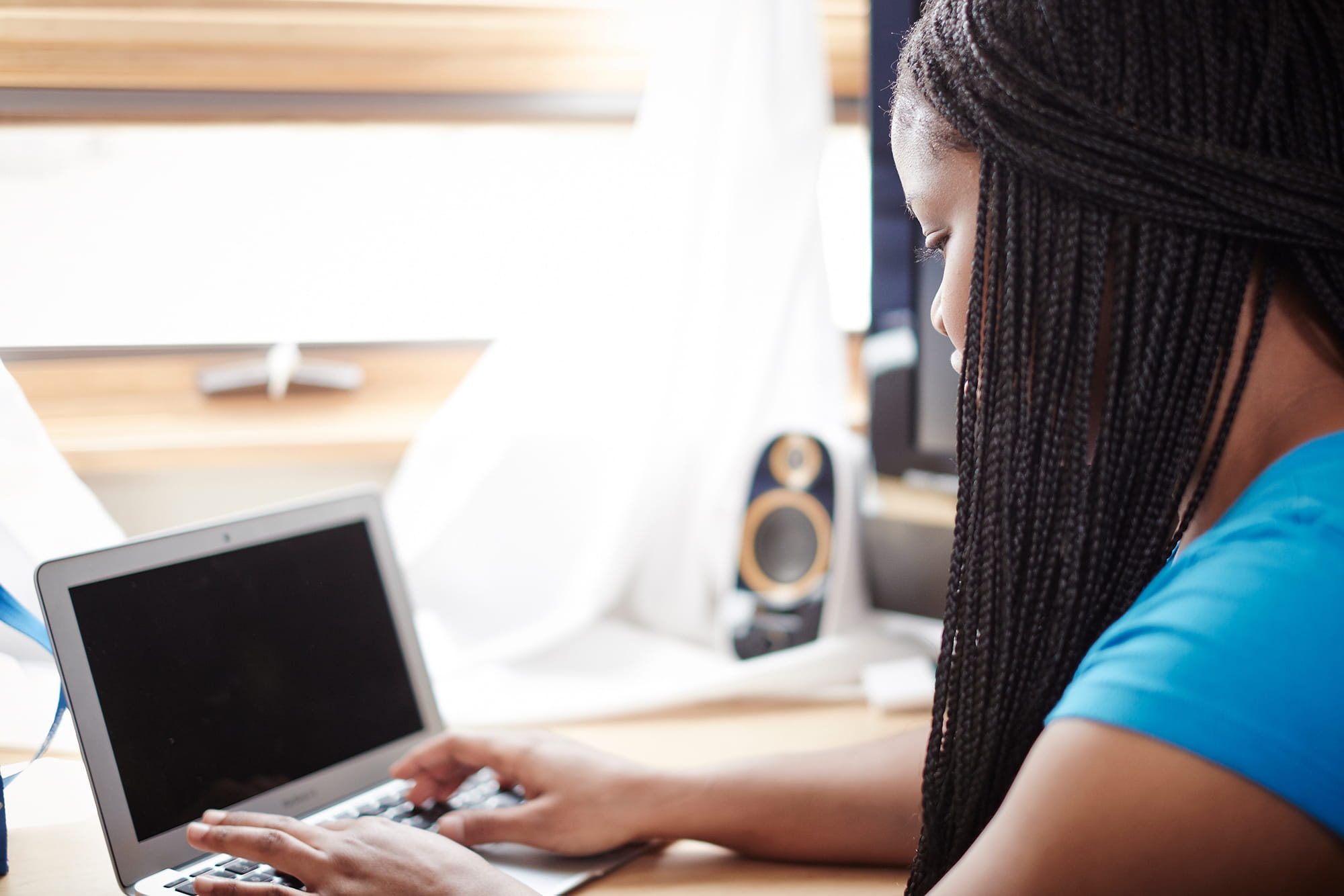 Woman on laptop in dorm room
