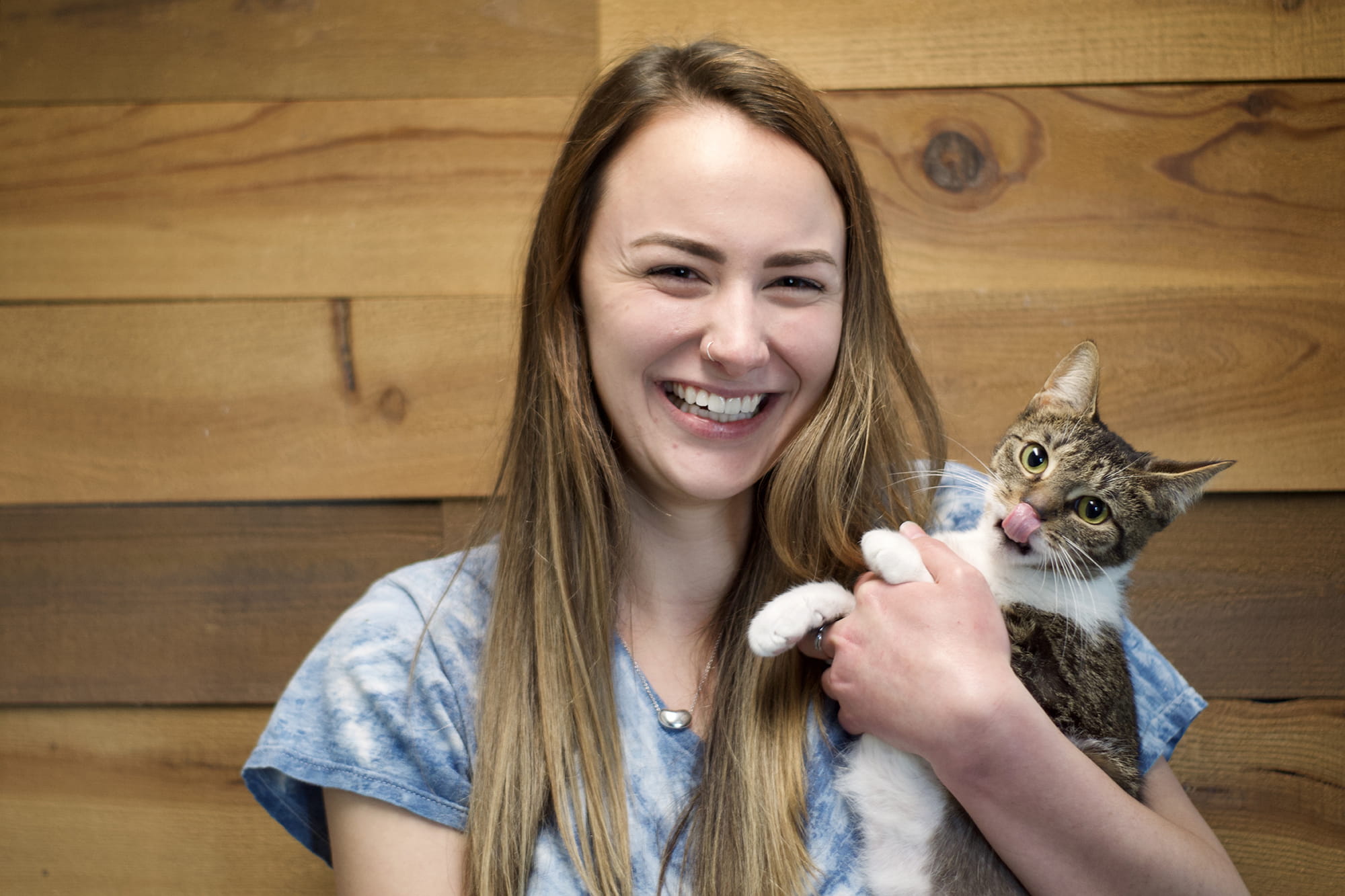 Sheridan Vet Tech student Cailey Seymour holding a kitten and smiling