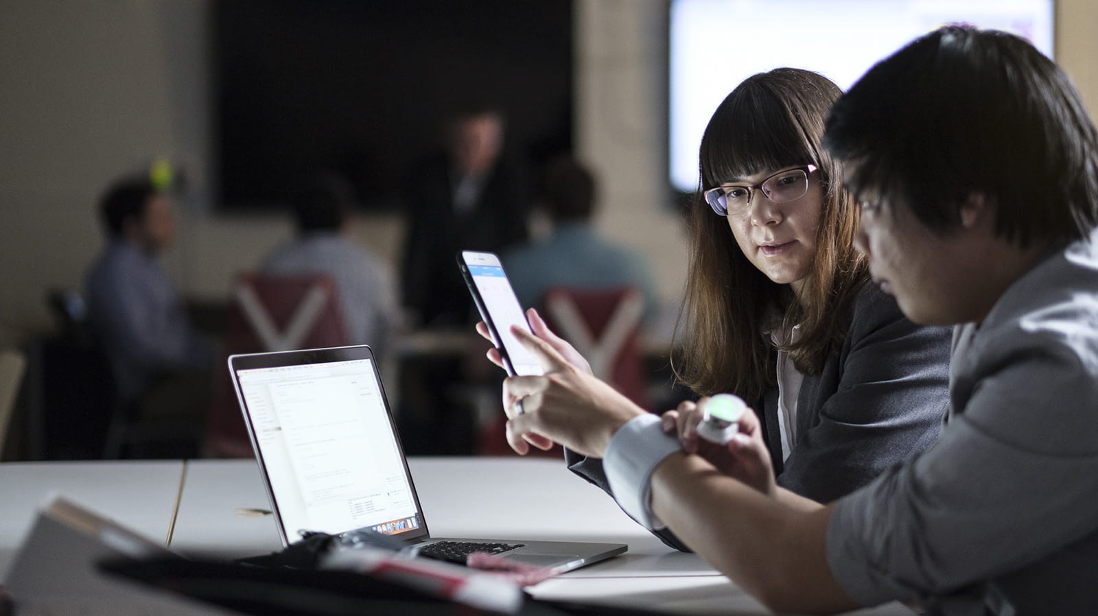 Two students working on a mobile application in class