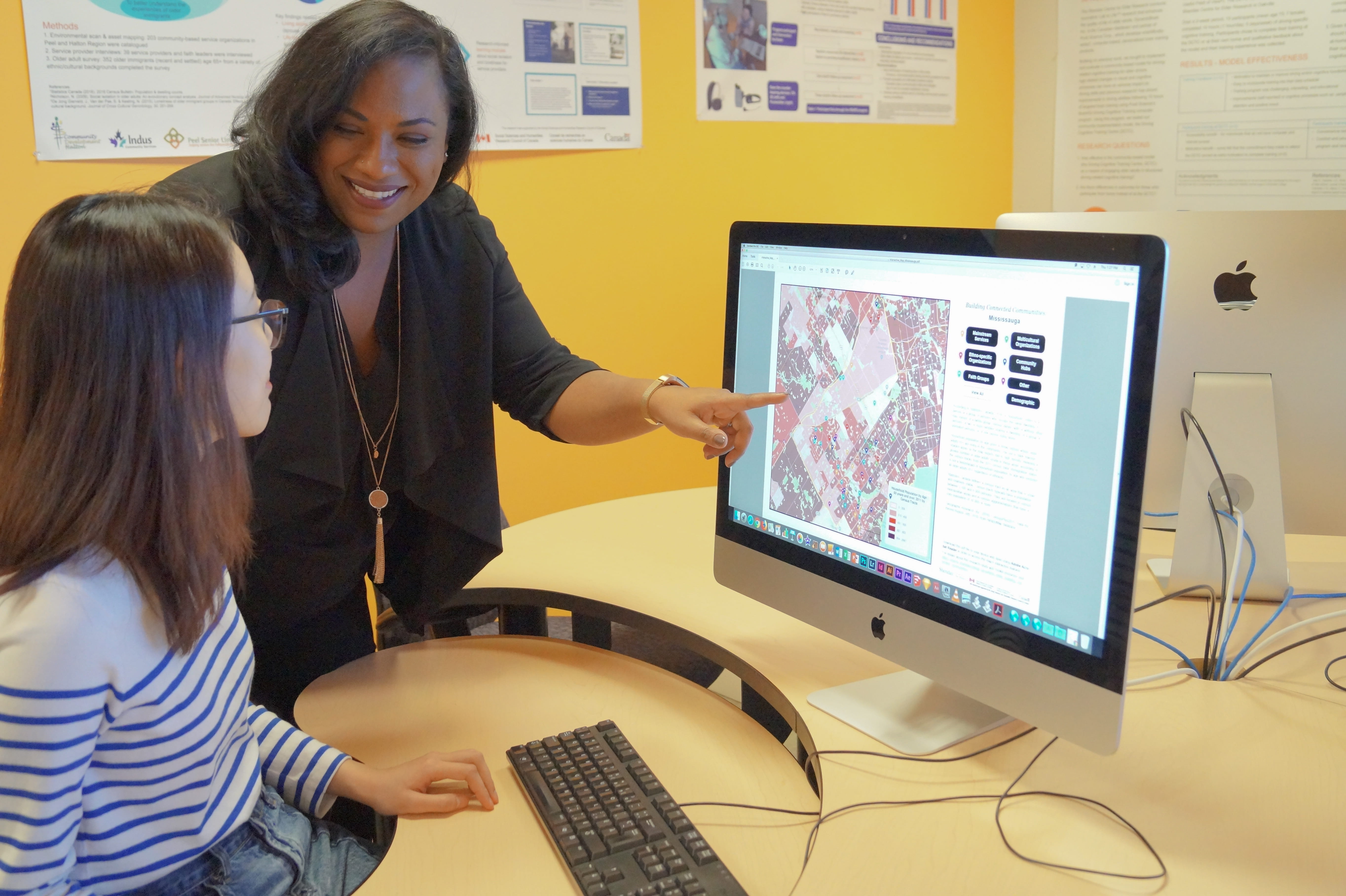 Professor and student looking at a computer screen