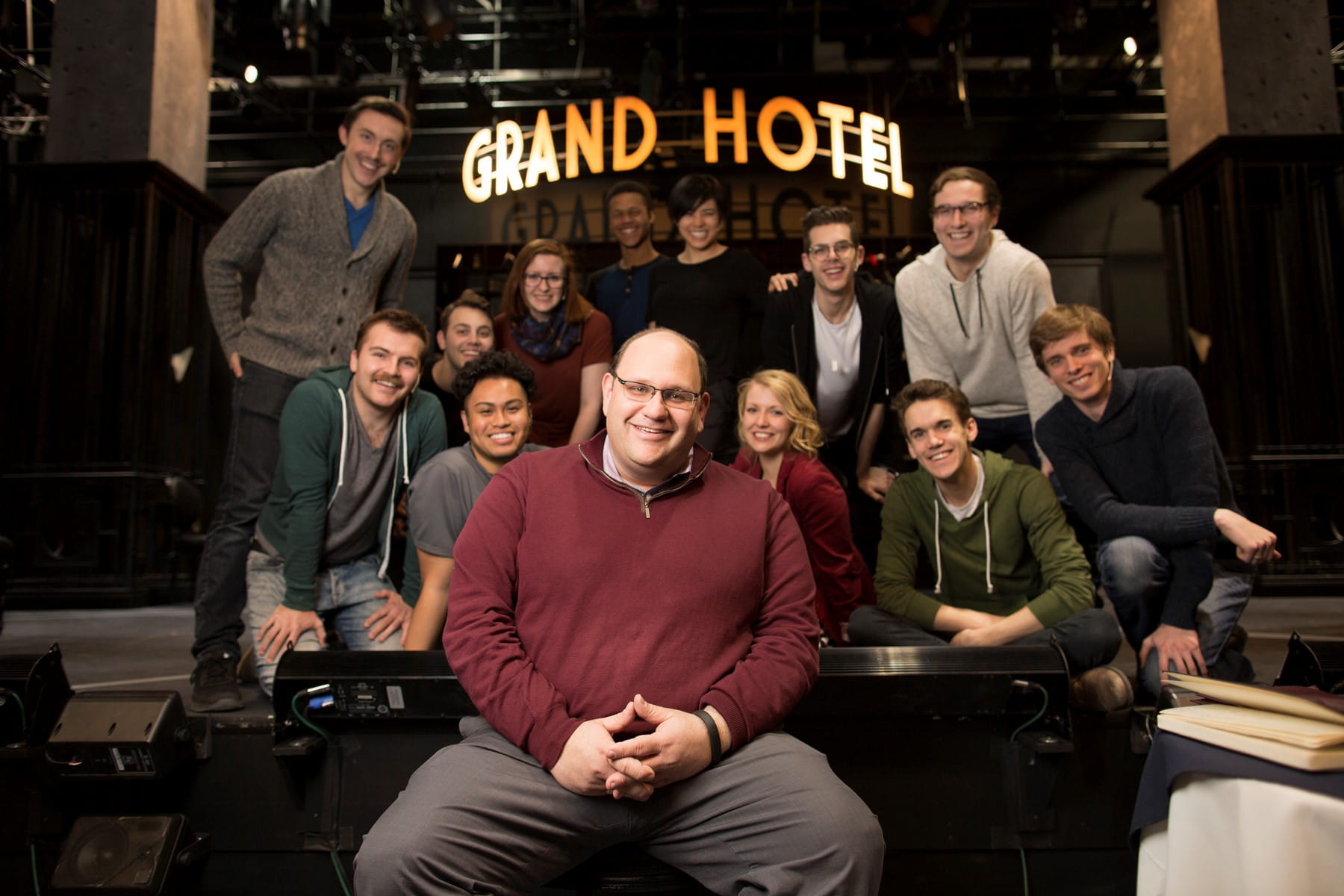 Michael Rubinoff and students in front of a Grand Hotel sign