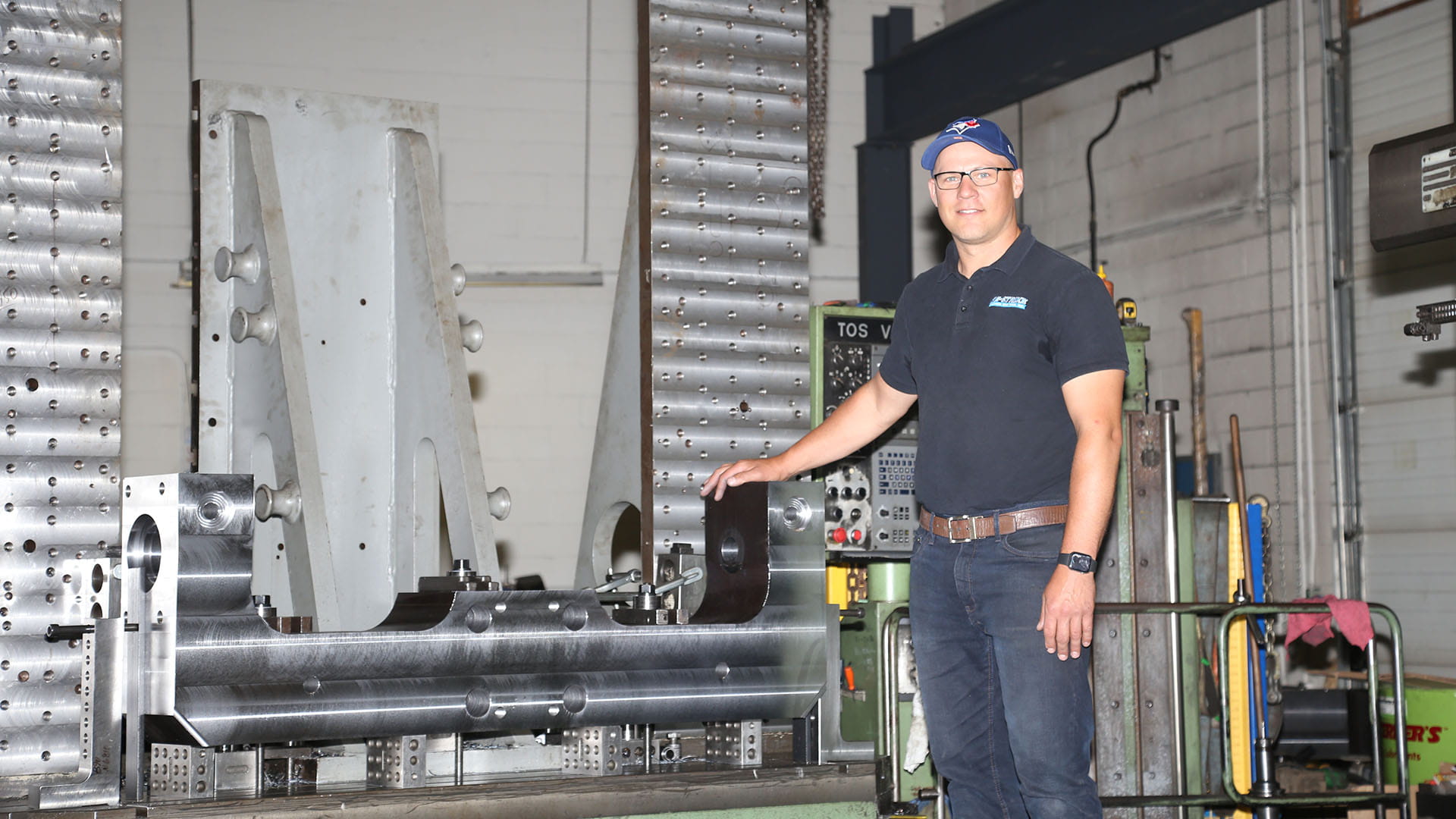 Sheridan graduate Kris Girdauskas posing in his shop, Re-Strike.
