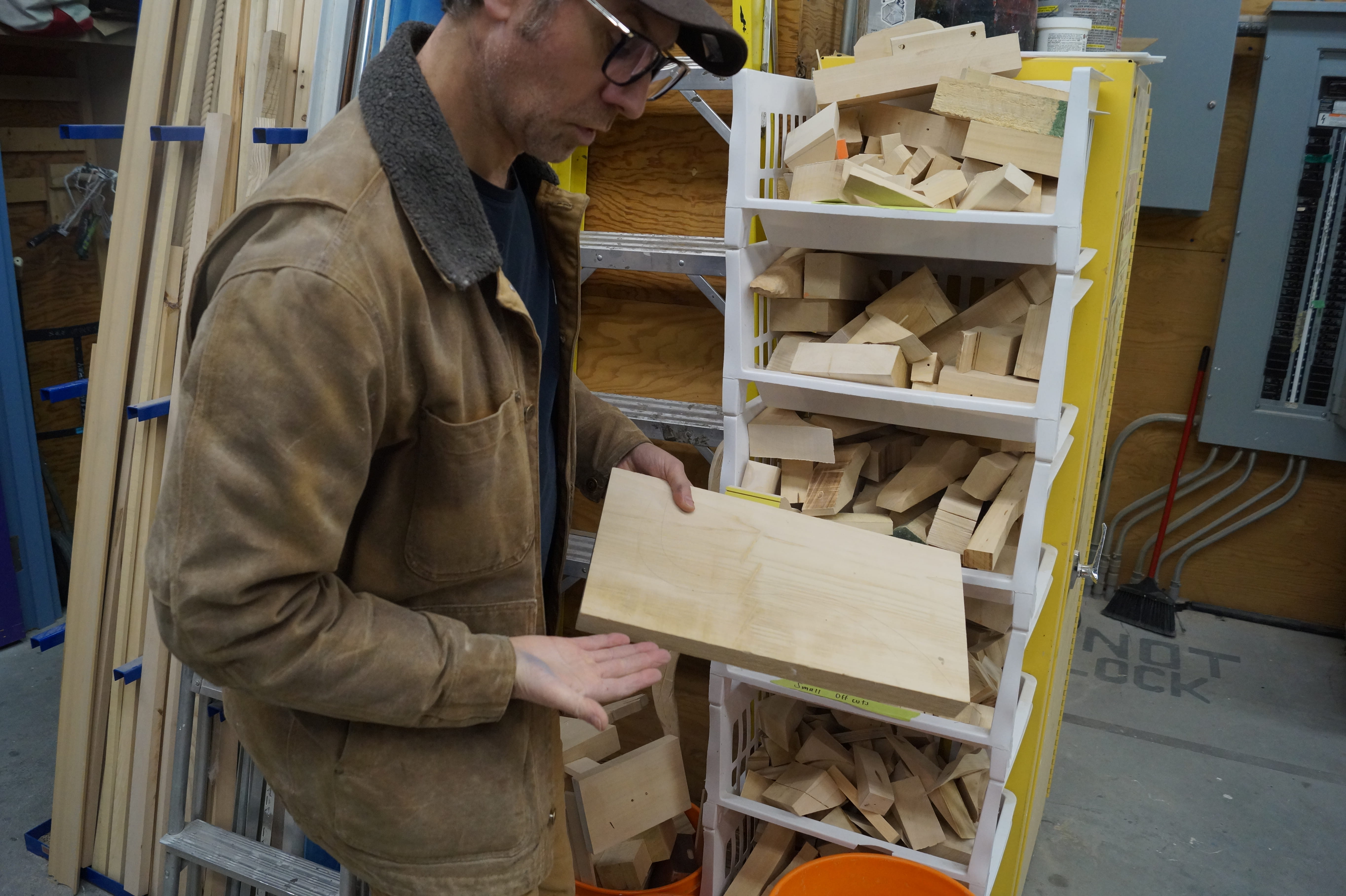 Program technologist Stephen Mazza holds a piece of off-cut wood.