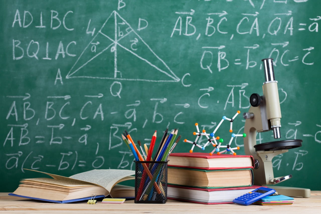 A graphic representing math and sciences, including formulas on a chalkboard and a microscope