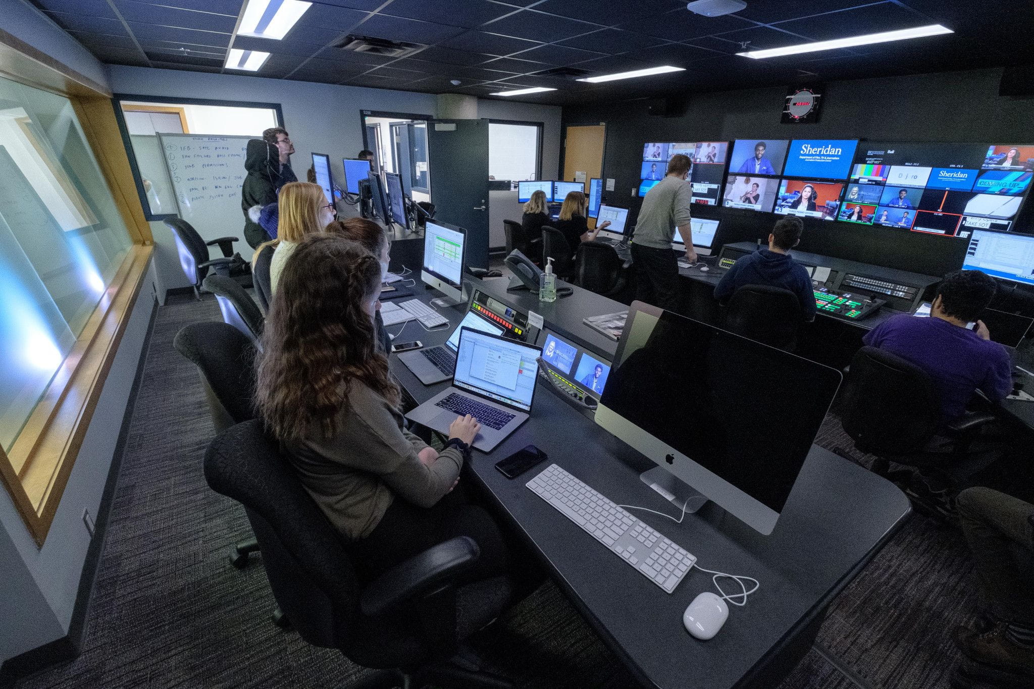 Students working in a broadcast control room at Sheridan College's Trafalgar Road Campus.