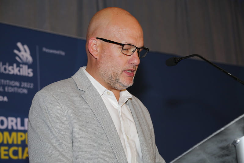 Steve Henry, Magna Director of Apprenticeship and Training, speaks during the closing dinner of the WorldSkills Competition 2022 Special Edition's Industrial Mechanics event.