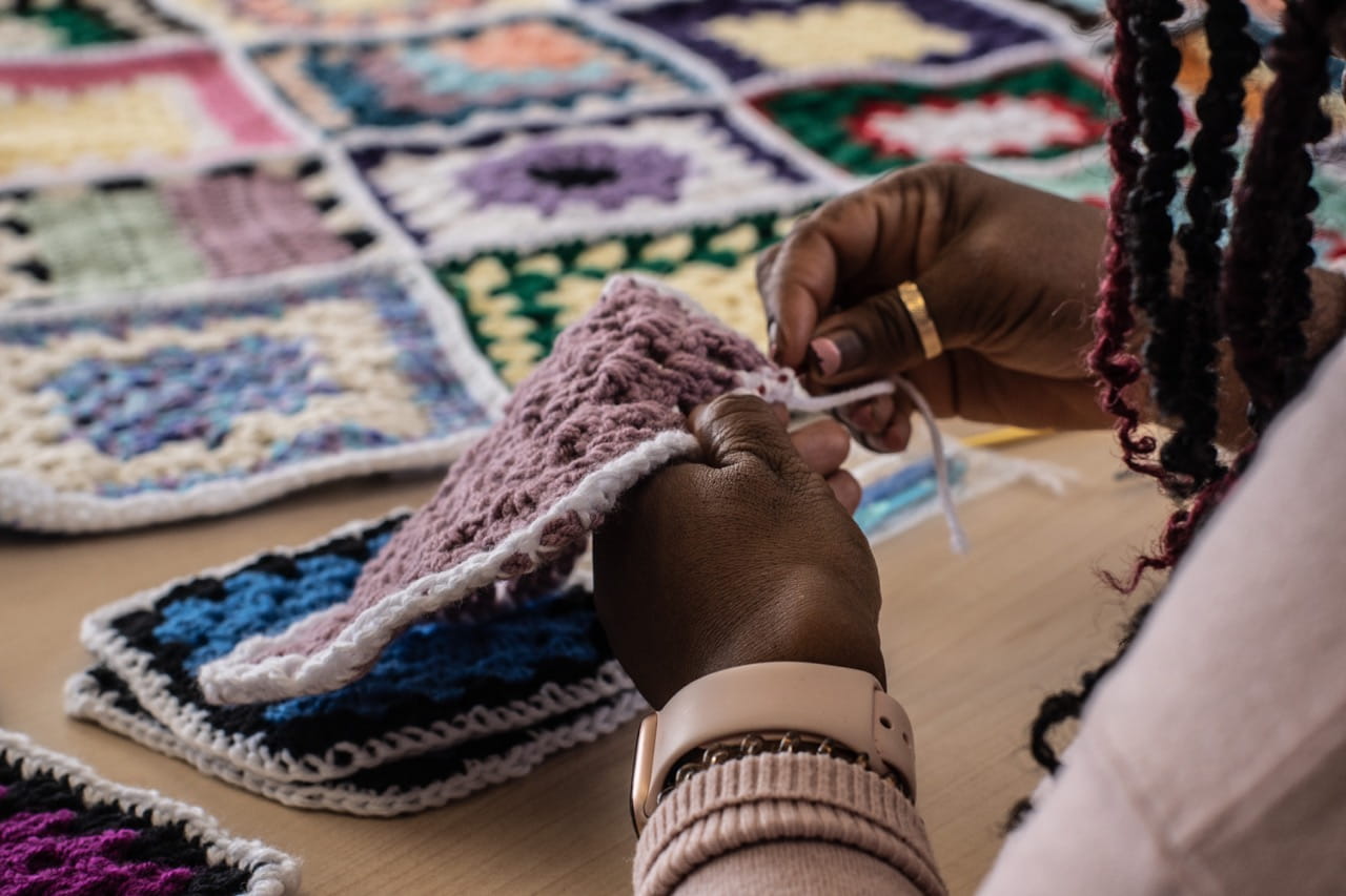 A close-up photo of a person crocheting a small towel