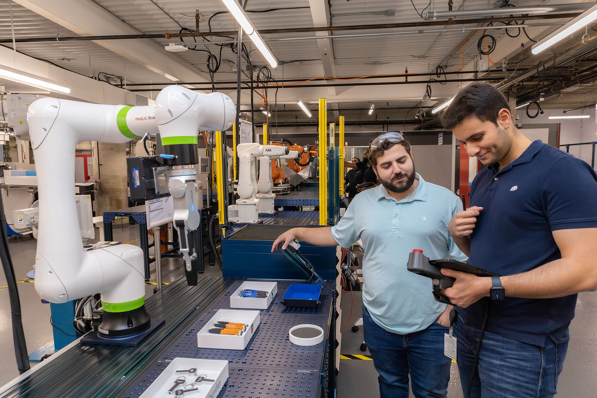 Two people working in a robotics lab