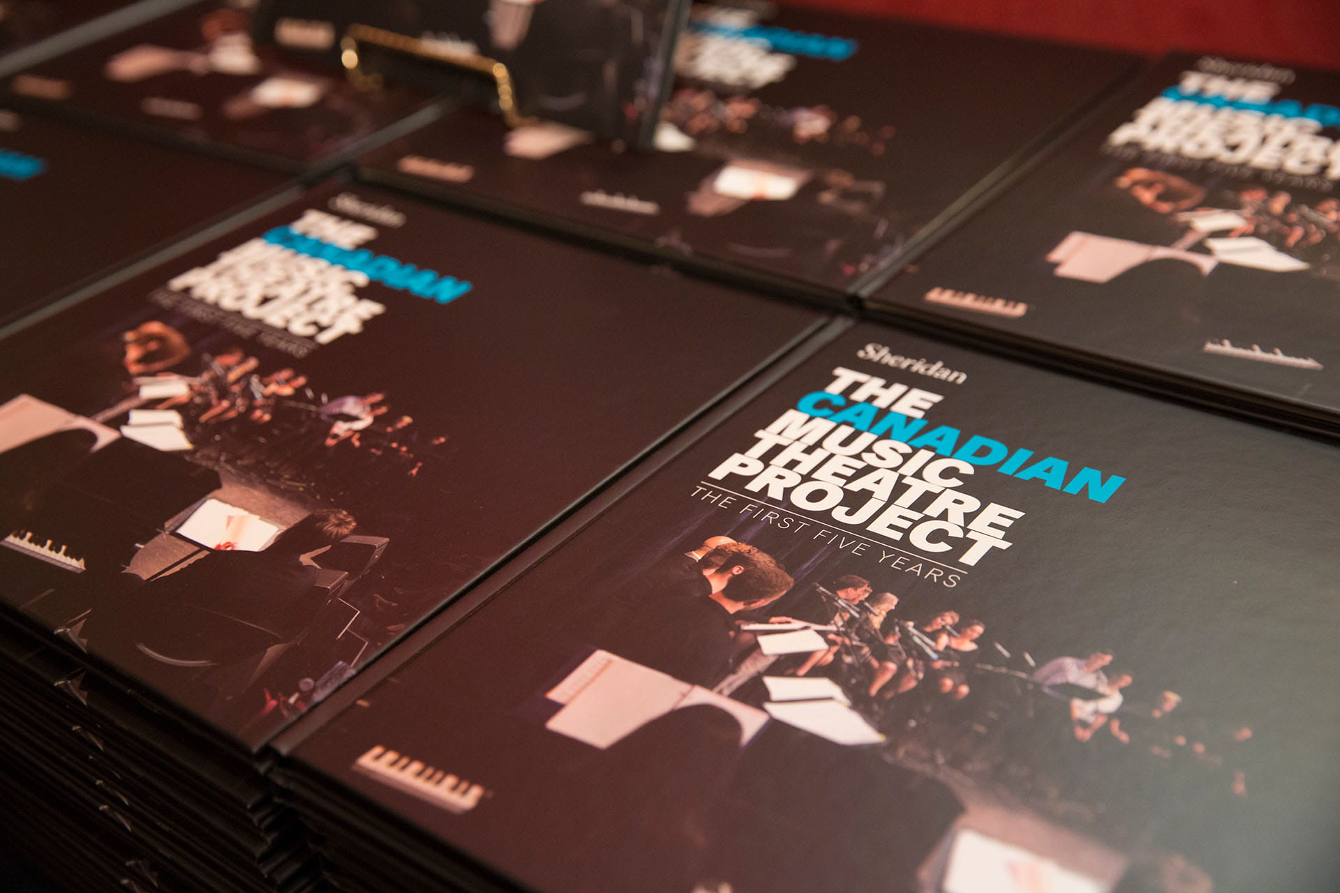 Stacked books. The Canadian Music Theatre Project. The First Five Years.